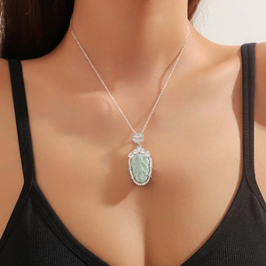 Elegant silver leaf necklace with emerald blue jade pendant and sparkling crystal inlay
