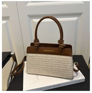 Detail der Strohhandtasche mit braunem Lederbesatz und Fashion Bag Schriftzug