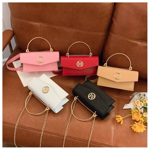 Detailed view of woven texture crossbody bags with metal M logo in various colors
