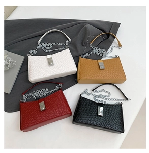 Detail of woven texture small square bags in four colors with silver chain straps