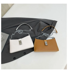 Detail of woven texture underarm bags with chain straps in white and brown leather