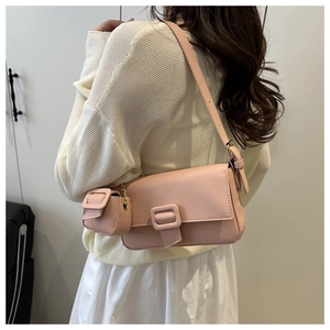 Detailed view of pink lychee pattern leather shoulder bag with matching mini coin purse