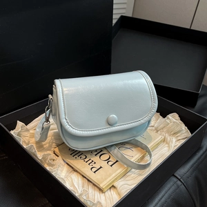 Minimalist light blue lychee pattern crossbody bag inside a premium gift box