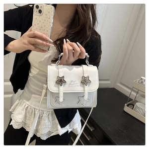 Close-up of white leather handbag with star studs and Bags Fashion HAPPINESS text