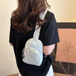 Minimalist nylon crossbody chest bag for commuting, shown as worn by model