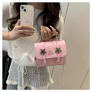 Detailed view of a pink mini crossbody bag with star decorations and matching floral phone case