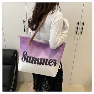 Detail of purple gradient canvas tote with frayed edges and brown leather strap