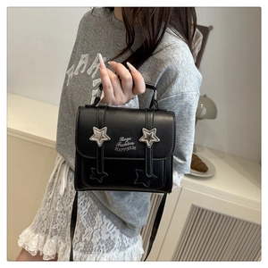 Detail of black crossbody bag featuring silver star buckles and Bags Fashion printing