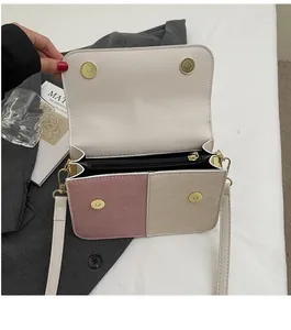 Detail of woven texture PU leather on color-block crossbody bag with gold magnetic buckle