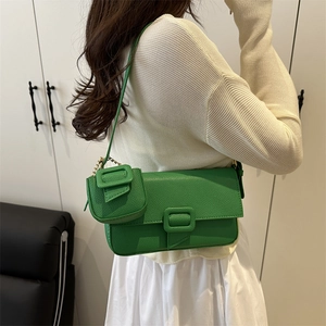 Chic lime green baguette shoulder bag with pebbled leather and matching mini pouch