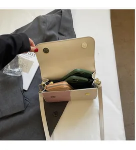 Top view of two-tone crossbody bag interior showing storage space for phones and wallet