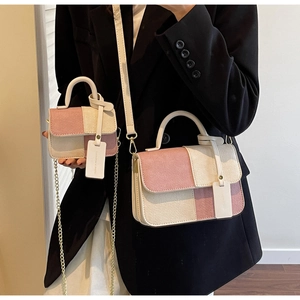 Detail of pink and beige woven pattern handbags with chain and leather straps