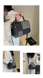 Detail view of two-tone crossbody bag with woven texture and gold hardware hooks