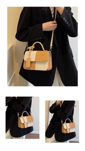 Detail of color-block beige and tan corduroy crossbody bag with rounded handle and strap