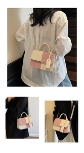 Detail view of pink and beige patchwork crossbody bag with textured corduroy fabric