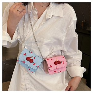 Detail of mini cherry print leather crossbody bags with rhinestone cherry buckles and chains