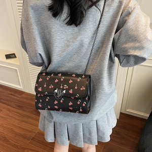 Chic black square crossbody bag with cherry prints and silver chain strap
