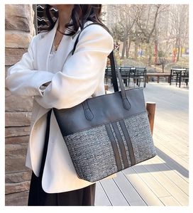 Close-up of a large patchwork PU leather tote bag with a woven texture detail