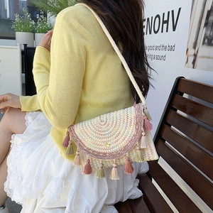 Bohemian straw crossbody bag with colorful geometric patterns and decorative tassels