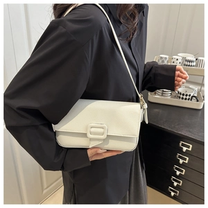Close-up of white lychee pattern faux leather crossbody bag with square buckle detail
