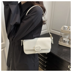 Detailed macro view of white pebble grain leather and fabric-covered square buckle detail