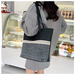 Detail of PU leather tote bag with tweed splicing and elegant white lace trim
