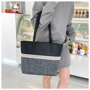 Detail of tweed and leather tote bag featuring white lace trim shown on model