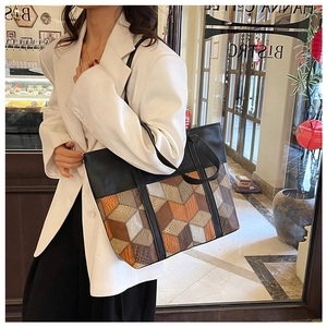 Detail shot of a large patchwork PU leather tote bag in retro geometric cube pattern