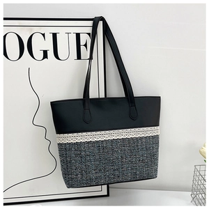 Close-up of black PU leather tote with tweed texture and white lace detailing
