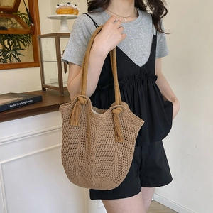 Handmade brown cotton woven shoulder bag with hollow mesh design for beach vacation