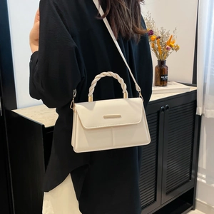 Minimalist cream white patchwork crossbody bag with woven handle and gold trim