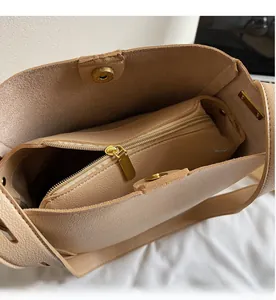 Macro view of beige leather bucket bag interior with magnetic clasp and smooth zipper
