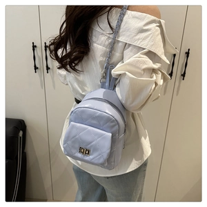 Detailed back view of a light purple quilted mini backpack with metal chain straps