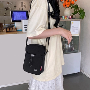 Black nylon mini crossbody phone bag with adjustable strap and fashion drawstring pocket