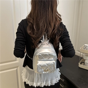Silver quilted mini backpack with metallic finish and elegant metal chain straps