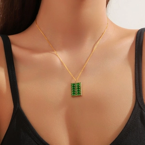 Collier en acier titane doré avec pendentif rectangulaire serti de zircons vert émeraude
