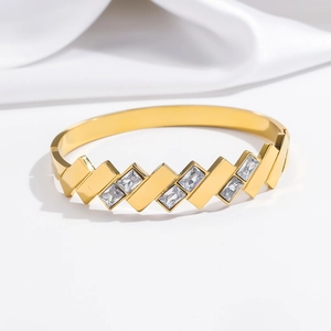 Macro shot of gold-plated stainless steel cuff featuring cubic zirconia in a zigzag design