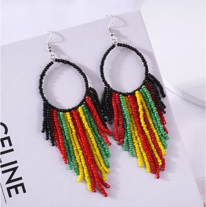 Macro detail of Bohemian hoop earrings featuring black beads and colorful fan-shaped tassels