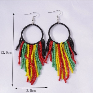 Handmade bohemian beaded tassel earrings in red yellow and green with black circle hooks