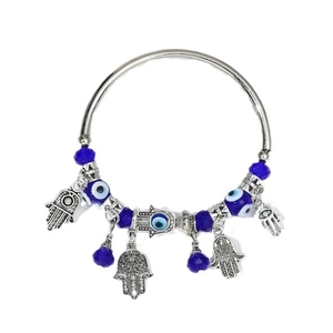 Silver Hamsa Hand and Evil Eye charm bracelet with deep blue beads on white background