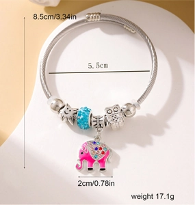 Detailed view of silver wire bracelet with owl bead and colorful pink elephant charm