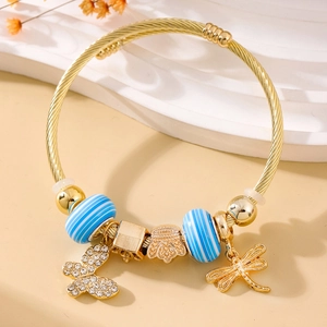 Elegant gold coiled bracelet featuring blue beads and sparkling crystal animal charms