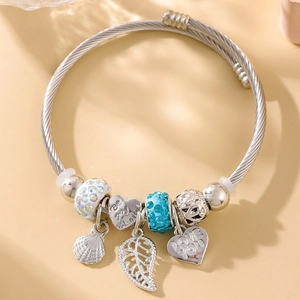 Detail of silver beaded bracelet with heart pendants engraved with Love You and Be my Valentine