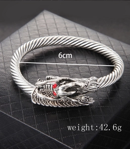 Detail of silver dragon bracelet with red eyes, 6cm inner diameter and 42.6g weight