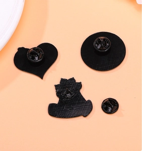Close-up of black matte cat paw pin backings and butterfly clutch pin fasteners