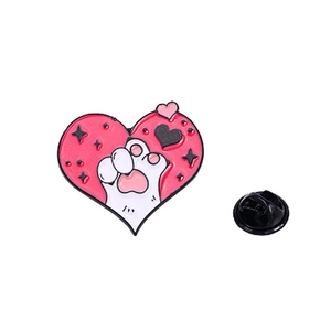 Detail of pink and white enamel cat paw heart pin with secure black butterfly clutch backing