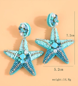 Detailed view of handmade beaded starfish earrings with blue rhinestones and pearls