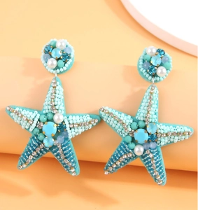Detailed macro shot of tiffany blue beaded starfish earrings with sparkling rhinestones