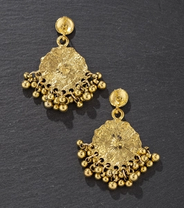 Detail of vintage gold flower drop earrings featuring a sunburst texture on dark stone