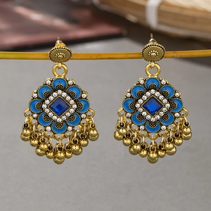 Bohemian vintage floral drop earrings with blue gems and metal tassels on a golden frame